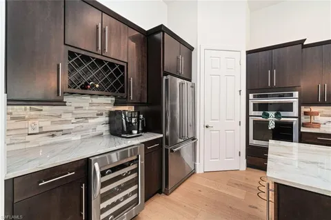 a kitchen with stainless steel appliances a refrigerator and a sink