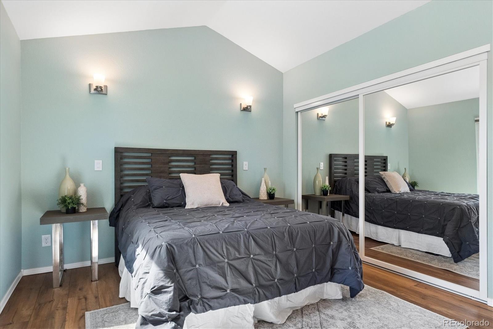 9377 Newport Lane Highlands Ranch, CO 80130 - Photo 11 of 26 a bedroom with a bed and wooden floor