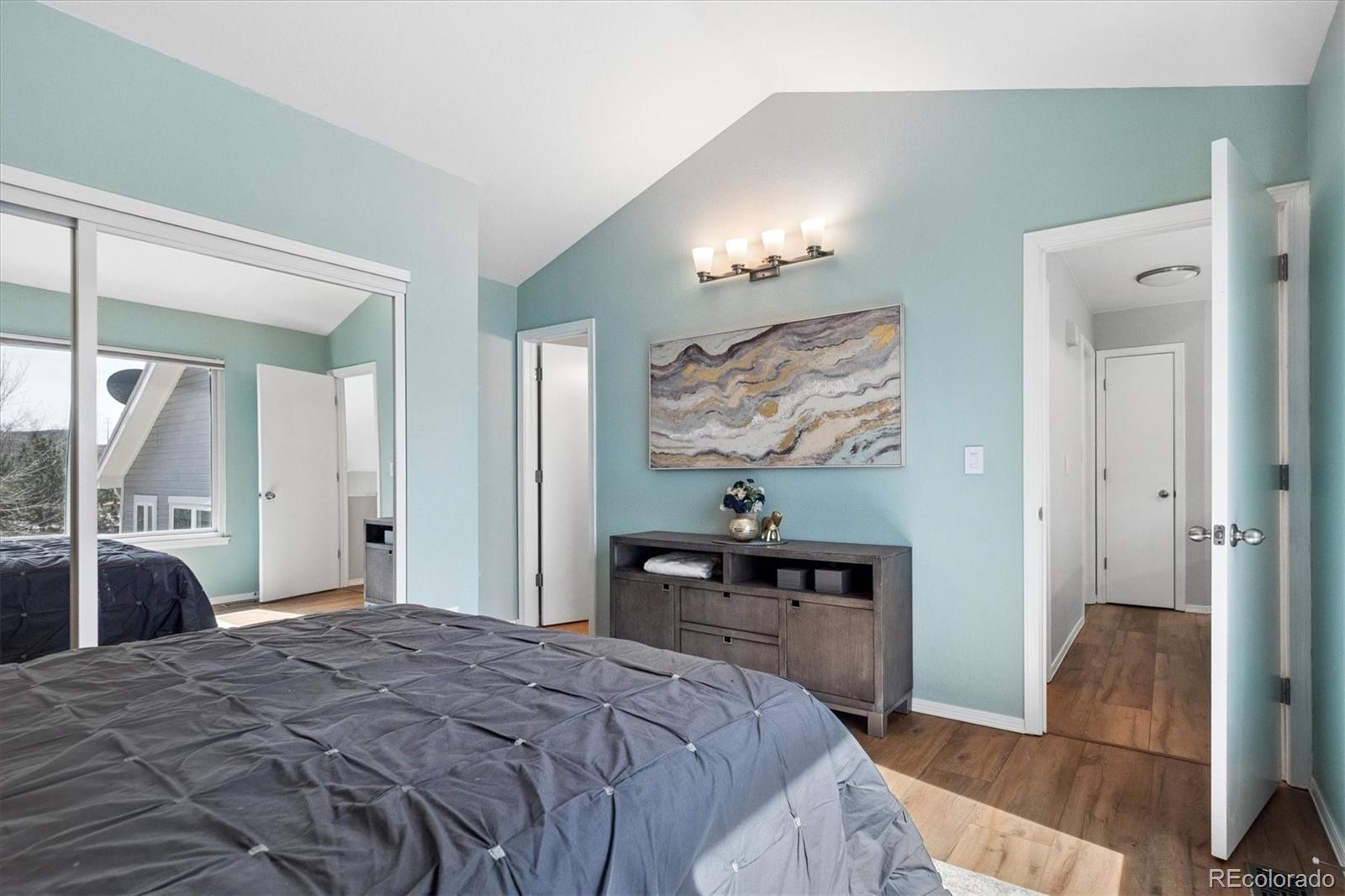 9377 Newport Lane Highlands Ranch, CO 80130 - Photo 12 of 26 a bedroom with a bed and a dresser with mirror