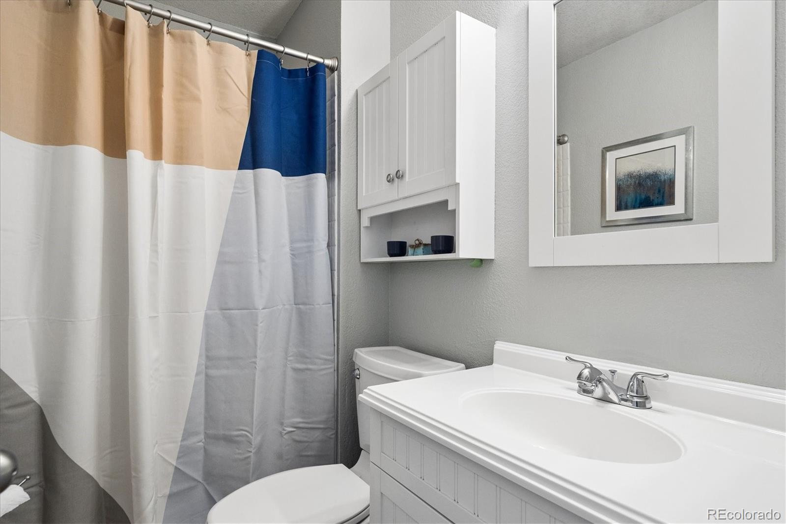 9377 Newport Lane Highlands Ranch, CO 80130 - Photo 14 of 26 a bathroom with a sink toilet and shower