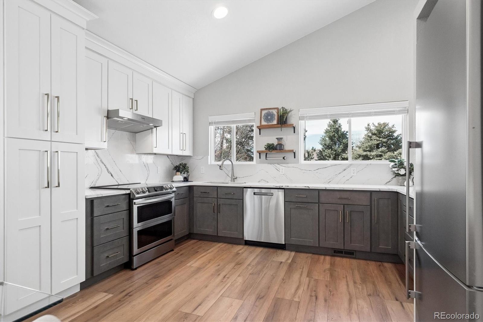 9377 Newport Lane Highlands Ranch, CO 80130 - Photo 7 of 26 a kitchen with stainless steel appliances granite countertop a stove and cabinets