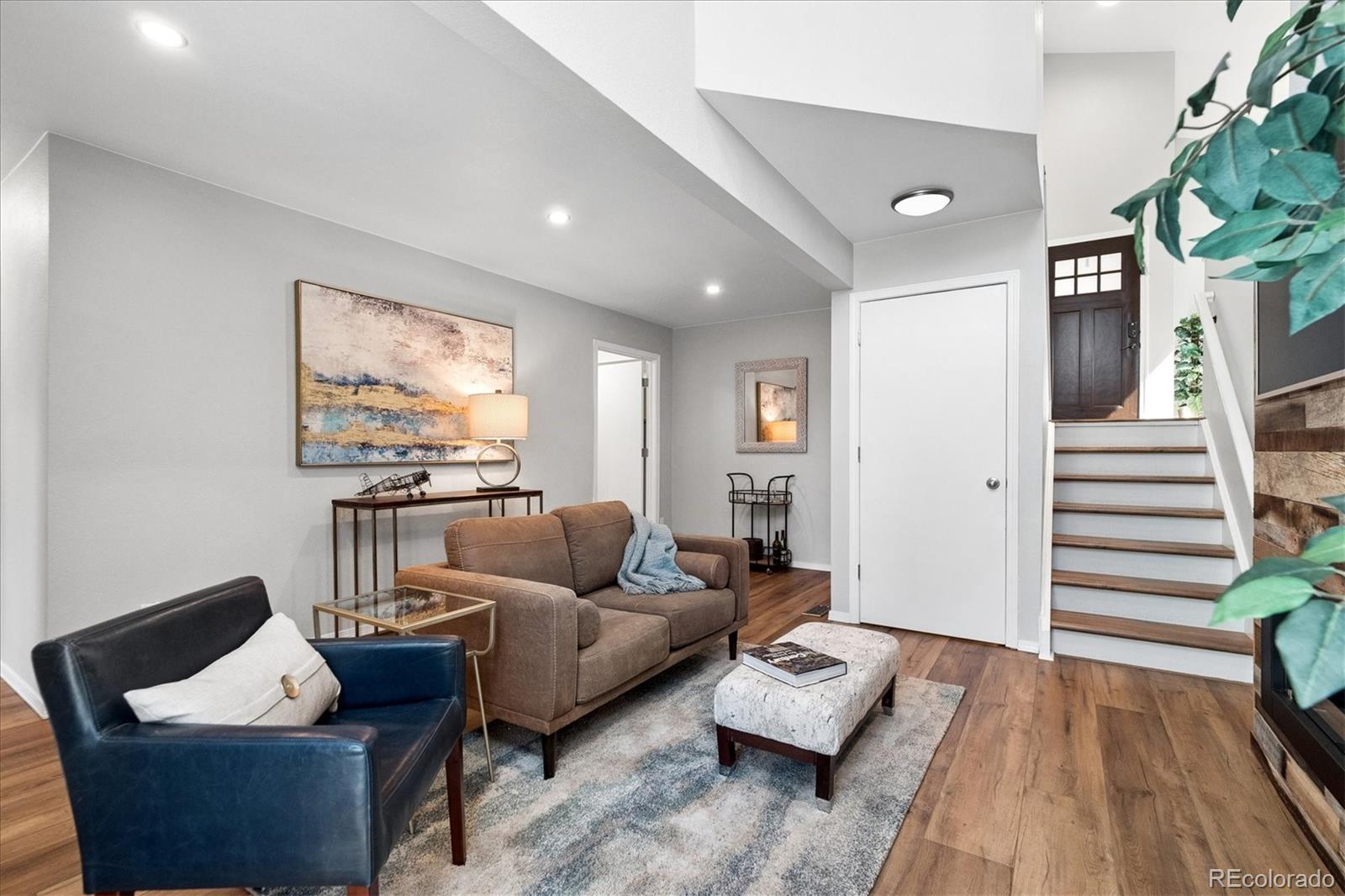 9377 Newport Lane Highlands Ranch, CO 80130 - Photo 10 of 26 a living room with furniture and wooden floor