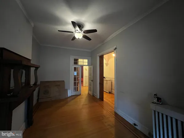 a view of a hallway with wooden floor