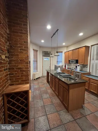 a kitchen with stainless steel appliances granite countertop a stove and a refrigerator