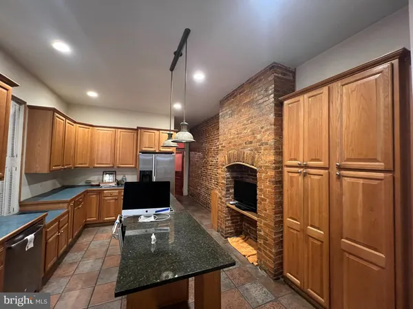 a kitchen with stainless steel appliances granite countertop a refrigerator stove and microwave