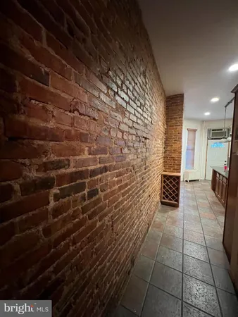 a bathroom with a brick wall