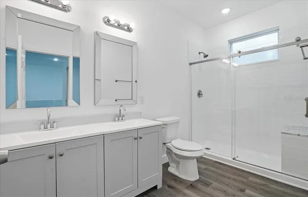 a bathroom with a toilet sink and mirror
