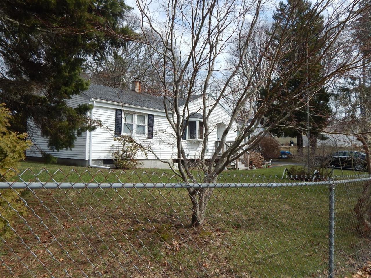 19 Millbrook Road Bourne, MA 02532 - Photo 4 of 7 a front view of a house with a yard