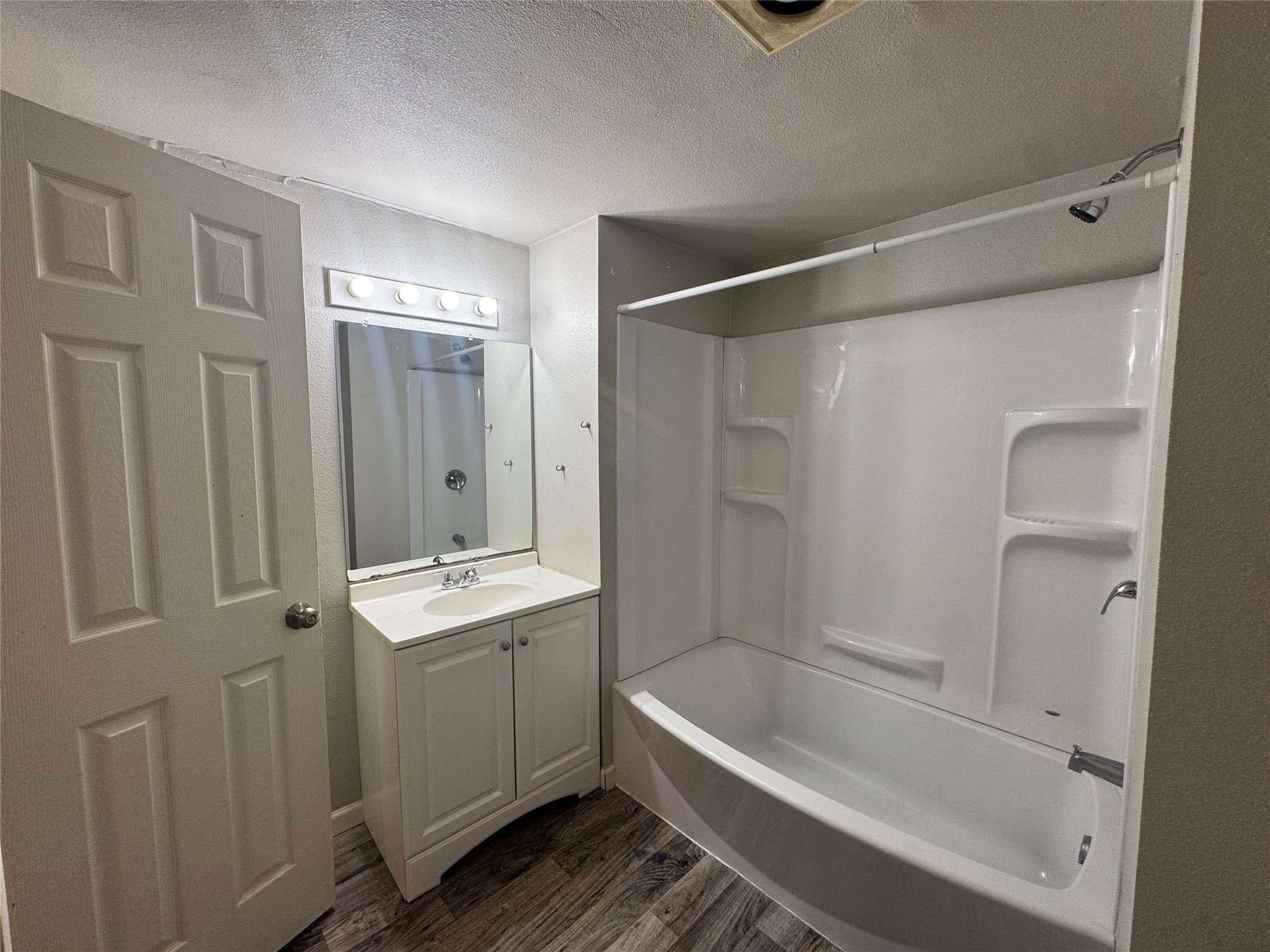5007 Heflin Lane Austin, TX 78721 - Photo 15 of 25 A well-appointed bathroom features a practical vanity with an integrated sink and a full-sized bathtub with shower.