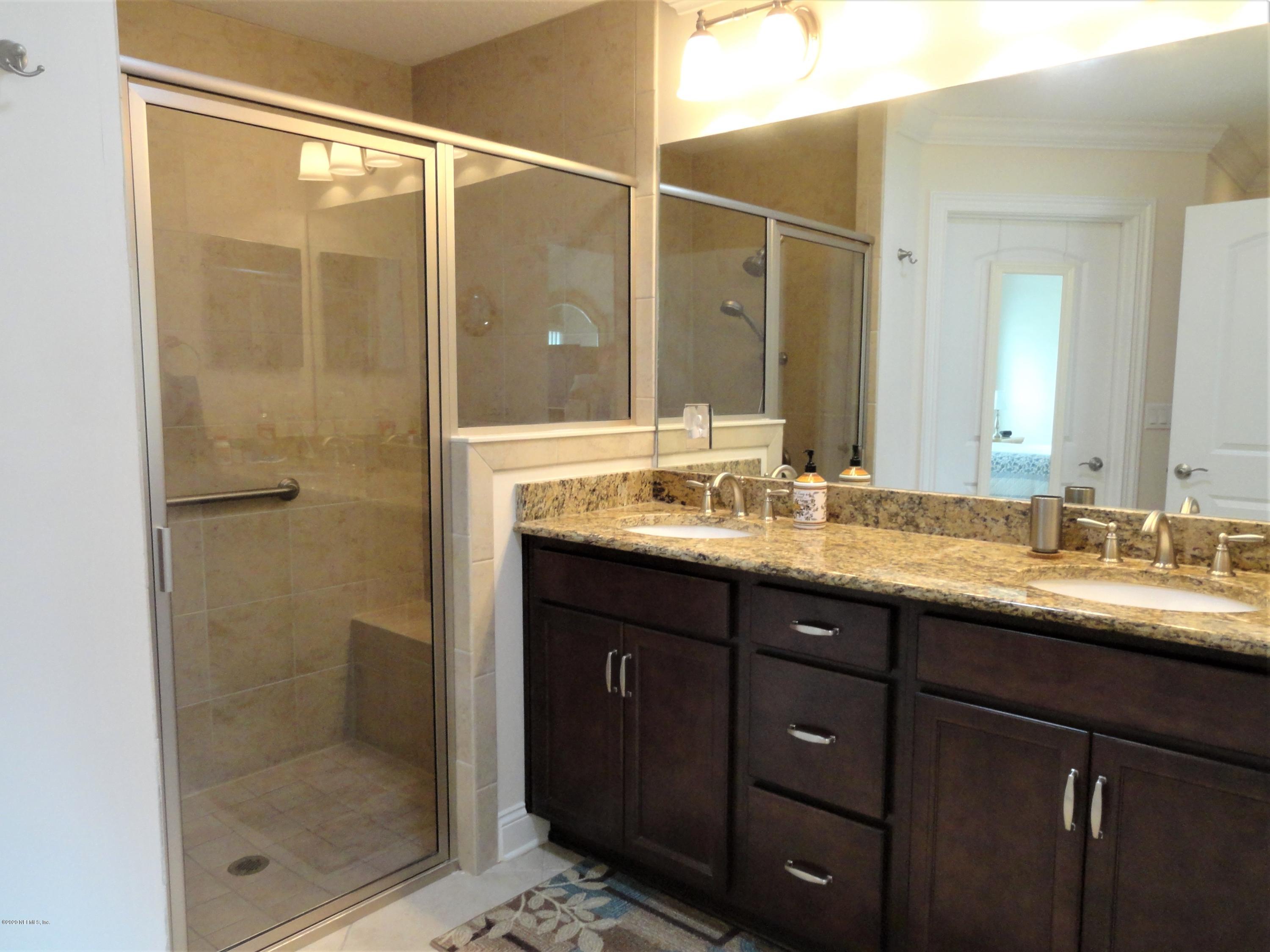 33 Utina Way St. Augustine, FL 32084 - Photo 17 of 30 a bathroom with a shower sink and mirror