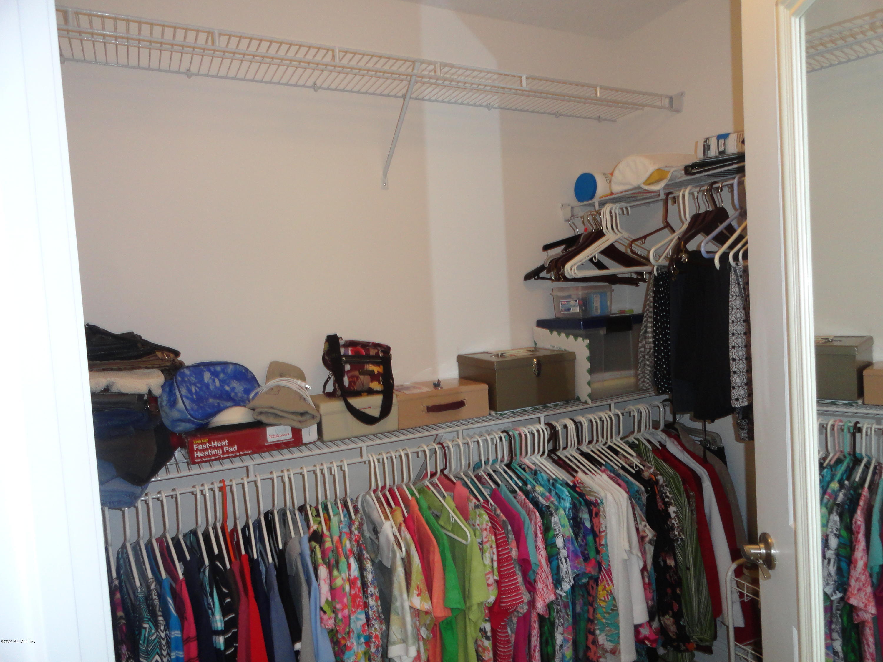 33 Utina Way St. Augustine, FL 32084 - Photo 19 of 30 a view of a bedroom with clothes and shoes