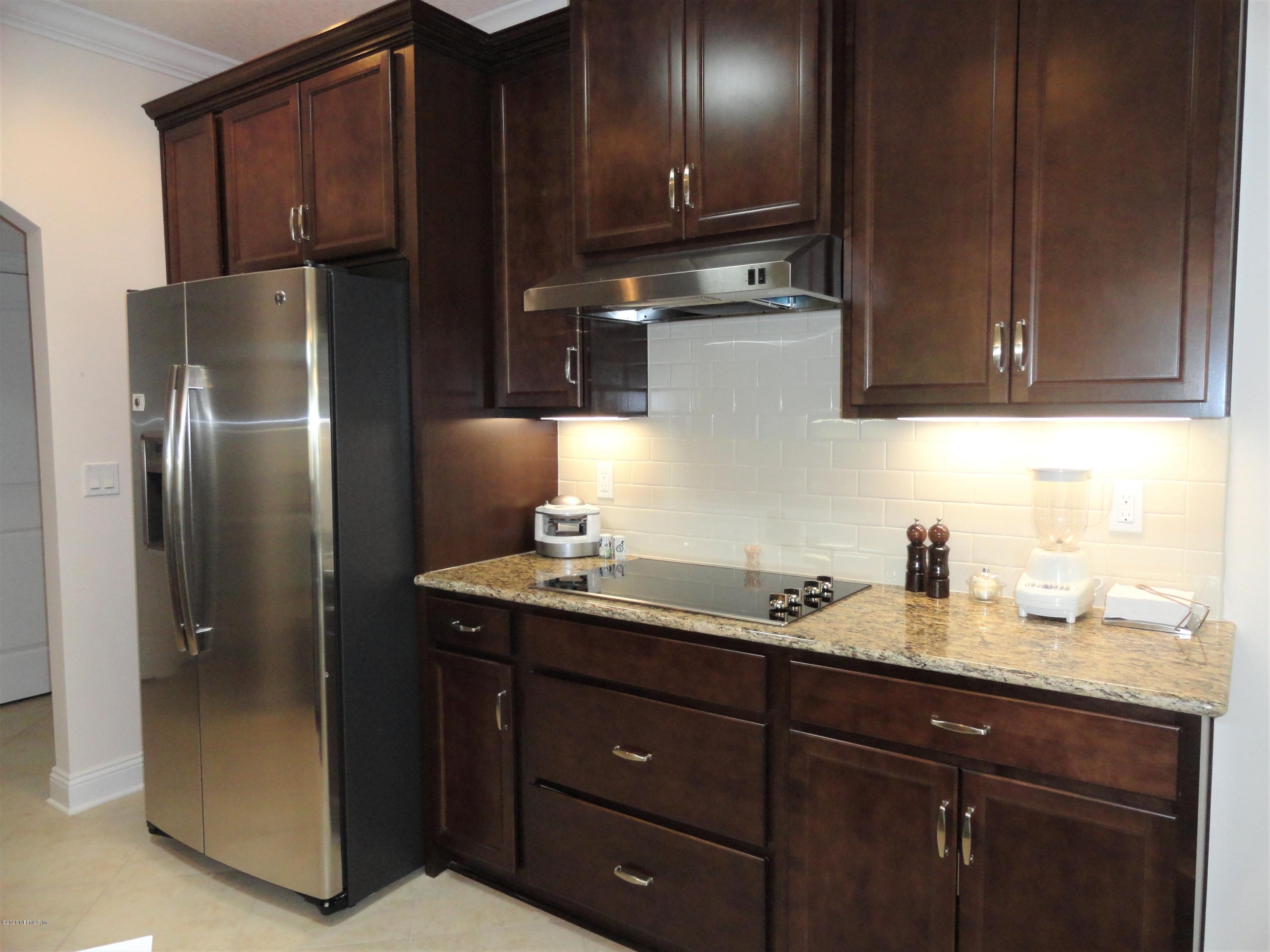33 Utina Way St. Augustine, FL 32084 - Photo 9 of 30 a kitchen with stainless steel appliances granite countertop a refrigerator and a sink
