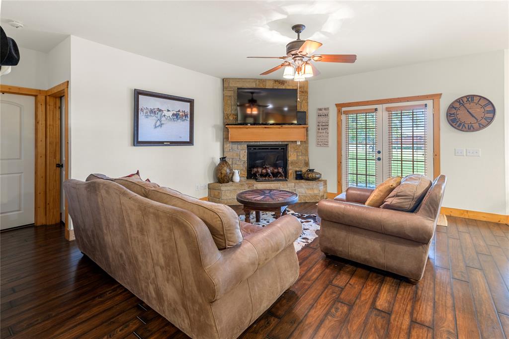 777 Stiles Road Whitesboro, TX 76273 - Photo 12 of 37 a living room with furniture and a fireplace