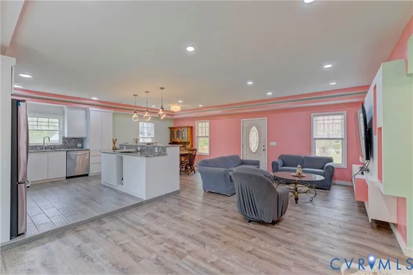 a view of a dining room with furniture and wooden floor