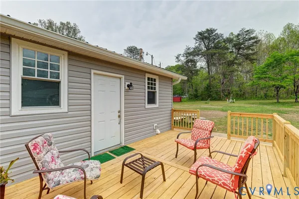 a view of a house with a yard and sitting area