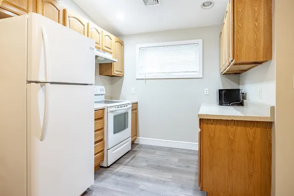a kitchen with stainless steel appliances a refrigerator sink and cabinets