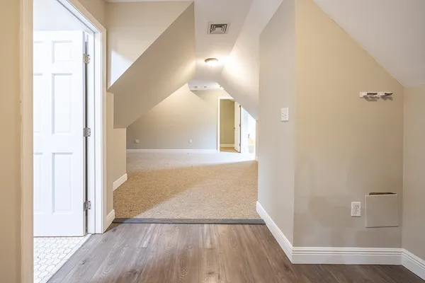 a view of hallway with wooden floor