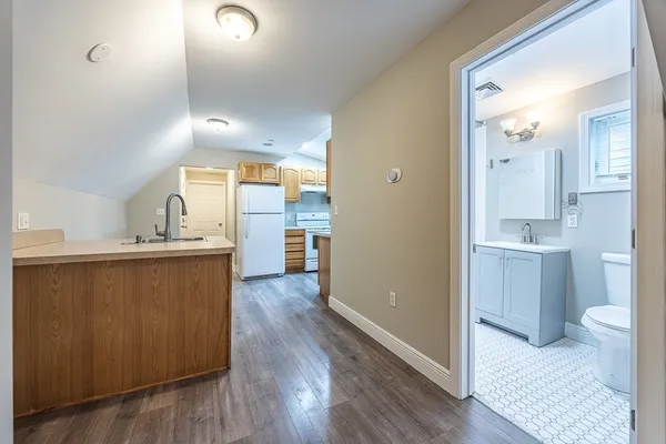 a view of a kitchen with a refrigerator and a sink