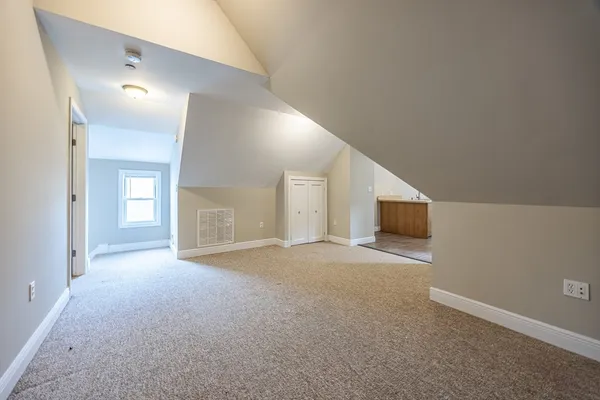a view of a livingroom with an empty space and a fireplace