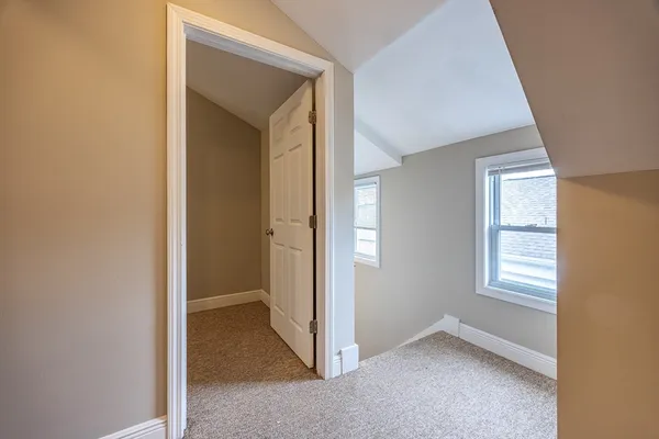 a view of an empty room with windows
