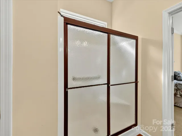 a bathroom with a glass shower door