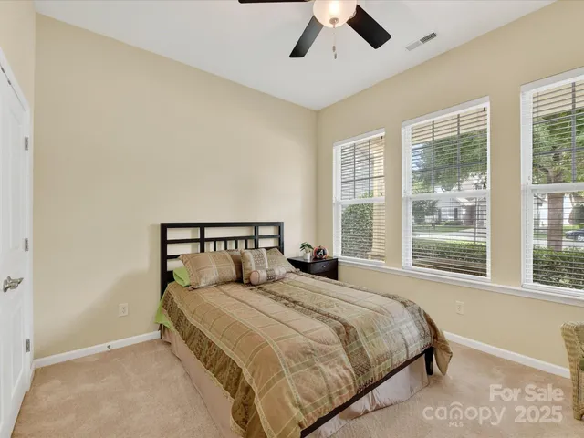a large bed sitting in a bedroom next to a window
