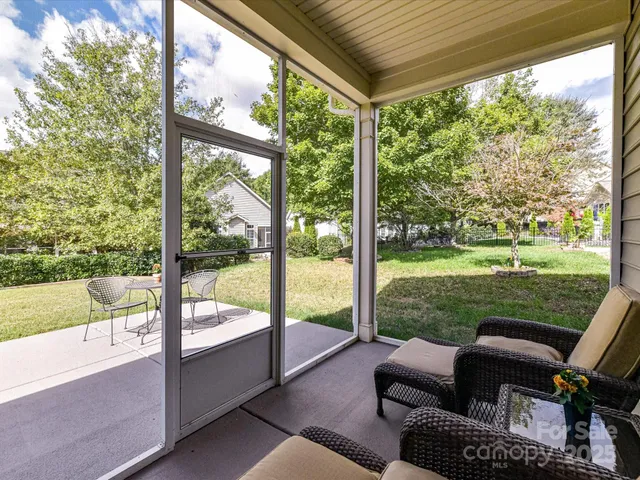 a balcony with furniture and a yard