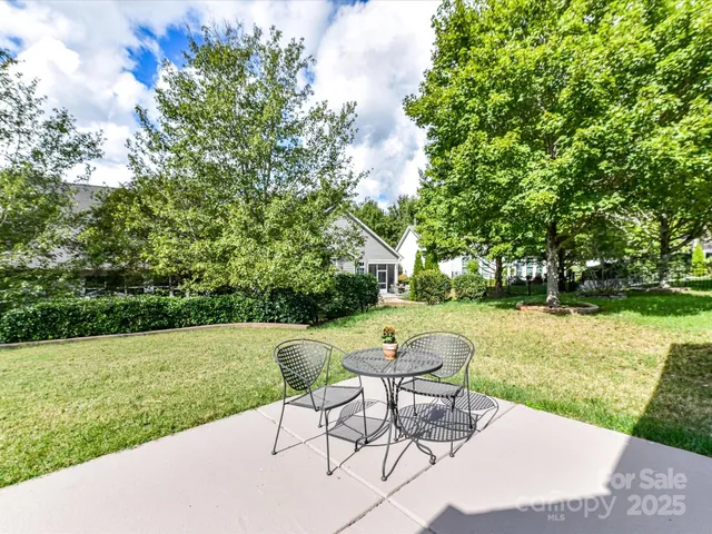 a view of a backyard with sitting area
