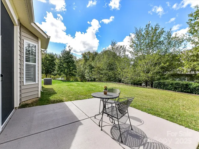 a view of a chair and table on the garden