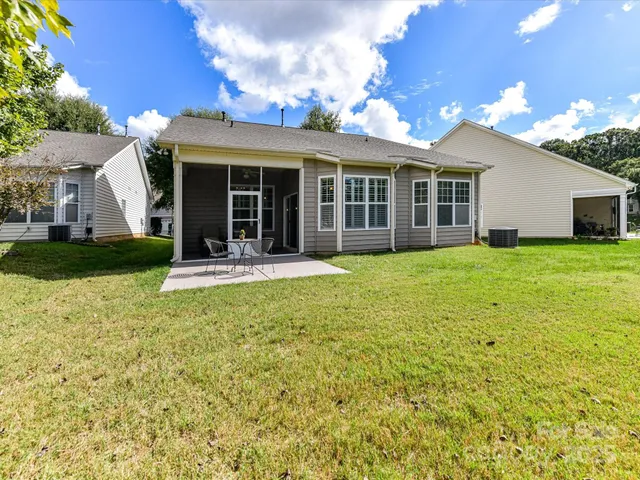 a view of a house with a yard and sitting area