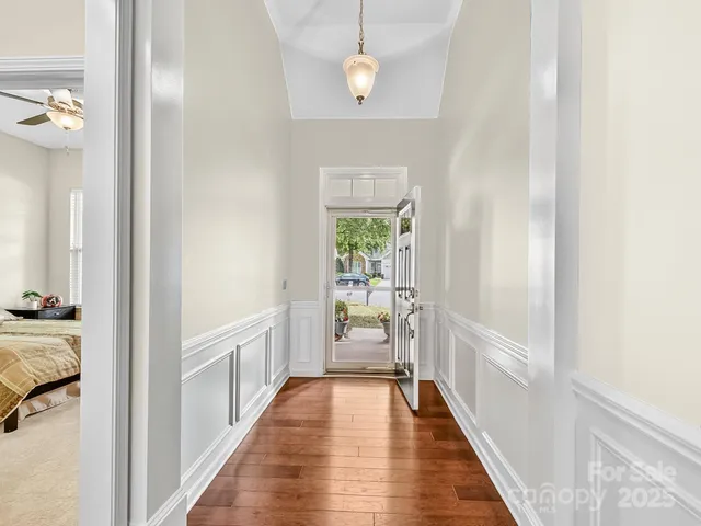 a view of a hallway view with wooden floor and staircase