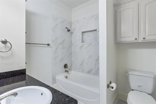 a bathroom with a sink a toilet and bathtub