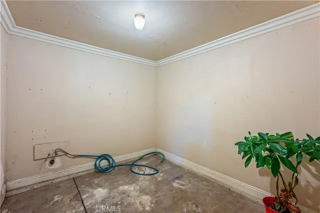 a view of a white house with a street