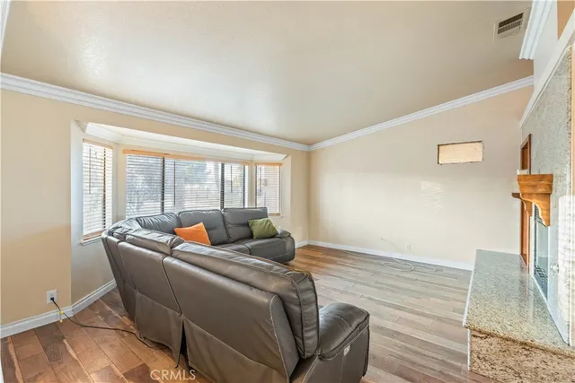 a living room with furniture and a floor to ceiling window