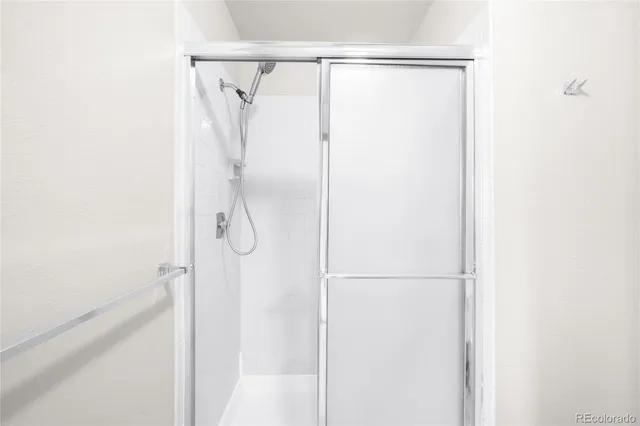 an empty room with a window and a kitchen