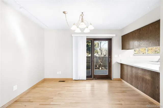 a kitchen with stainless steel appliances granite countertop a sink a stove a refrigerator and cabinets