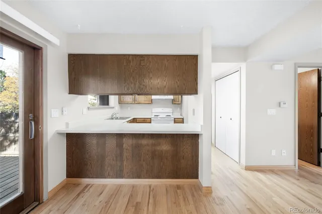 a white refrigerator freezer and a stove sitting inside of a kitchen