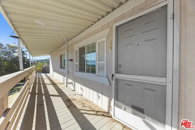 a view of balcony with wooden floor