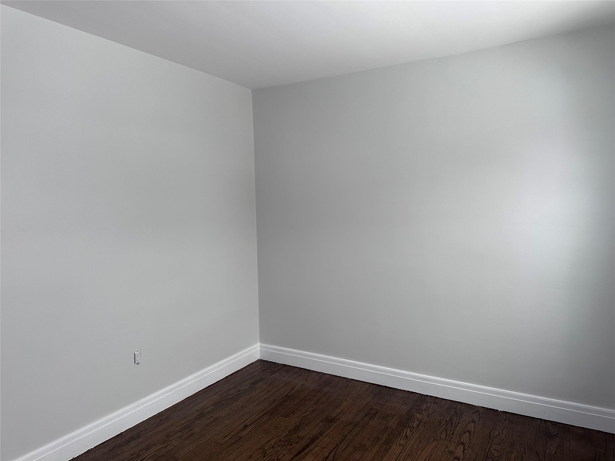 39 Adams Street, Unit 2 Poughkeepsie, NY 12601 - Photo 11 of 12 a view of an empty room with wooden floor