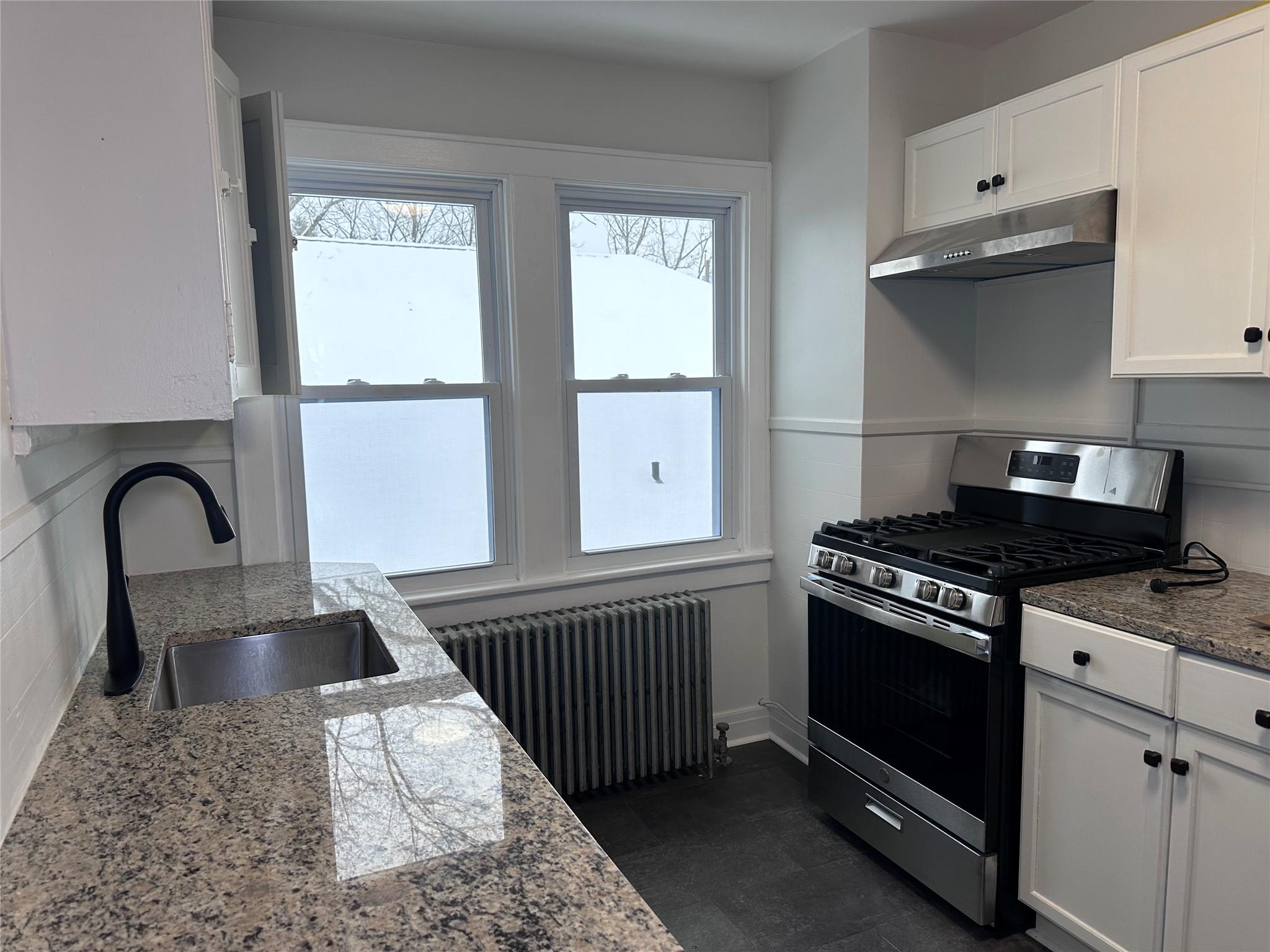 39 Adams Street, Unit 2 Poughkeepsie, NY 12601 - Photo 2 of 12 a kitchen with granite countertop a stove and a sink