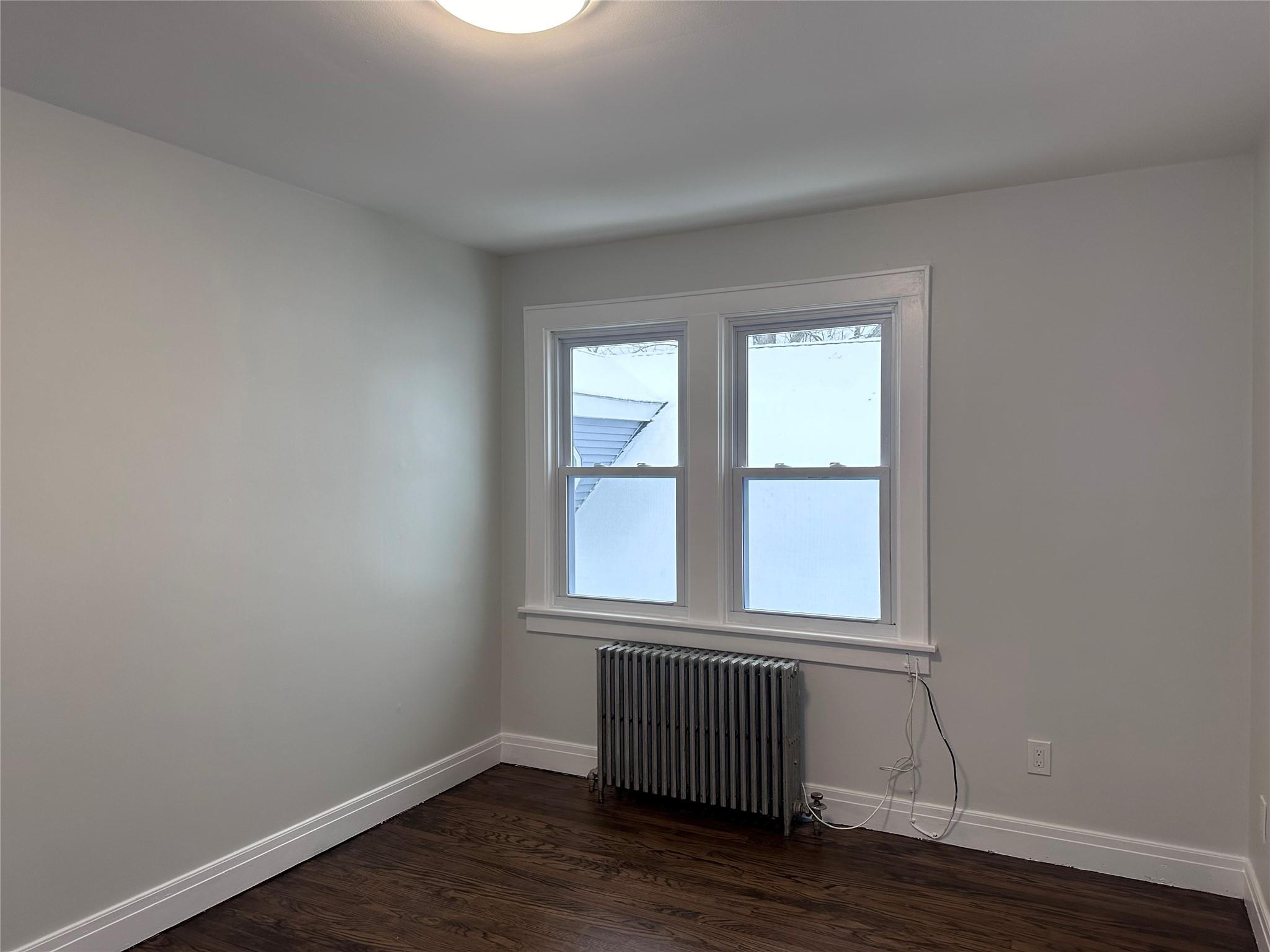 39 Adams Street, Unit 2 Poughkeepsie, NY 12601 - Photo 5 of 12 a view of an empty room with wooden floor and a window