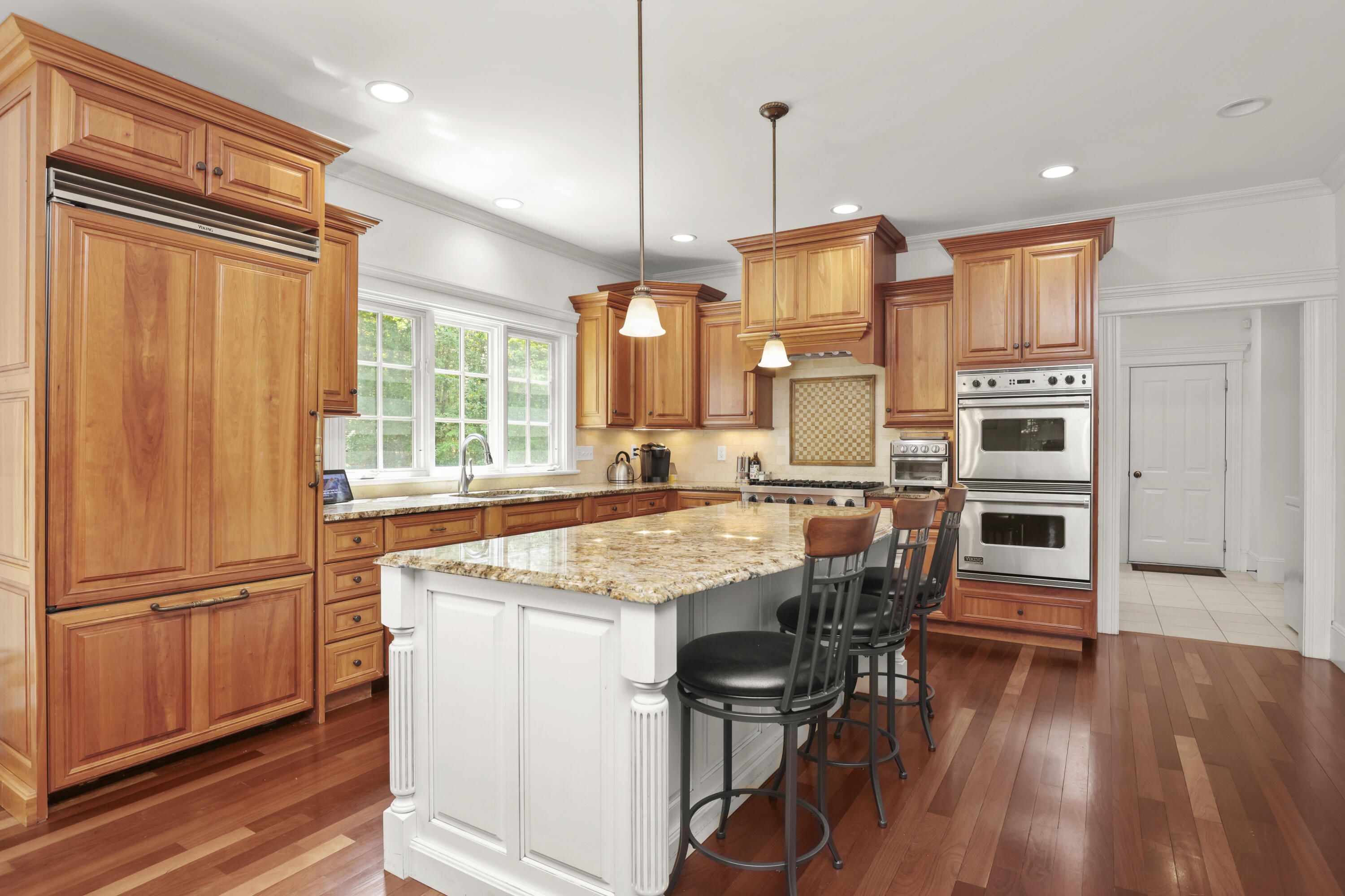 218 Limestone Road Ridgefield, CT 06877 - Photo 11 of 41 a kitchen with stainless steel appliances granite countertop a refrigerator a oven a sink and a dining table with wooden floor