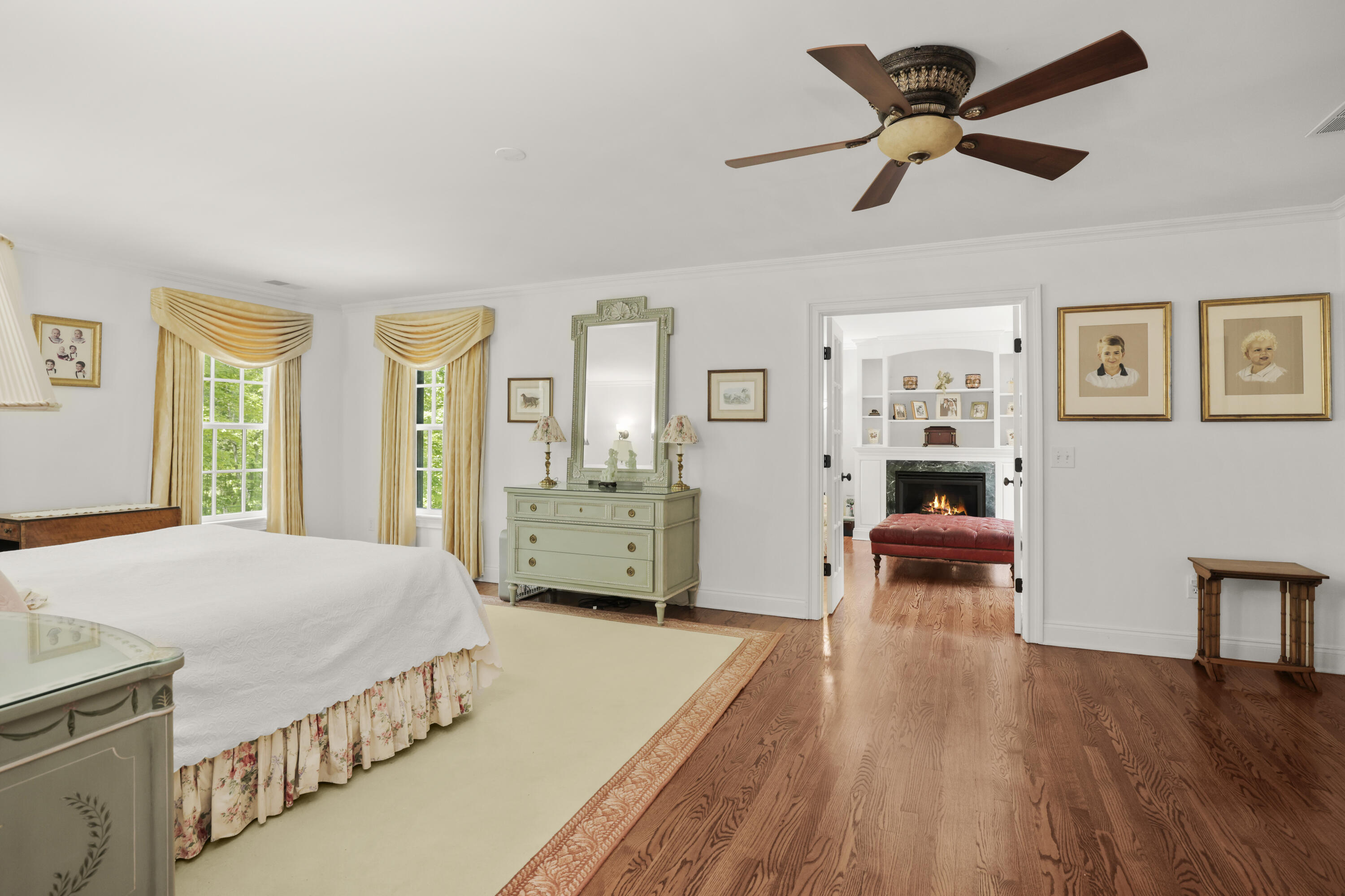 218 Limestone Road Ridgefield, CT 06877 - Photo 28 of 41 a spacious bedroom with a bed a table and a chandelier