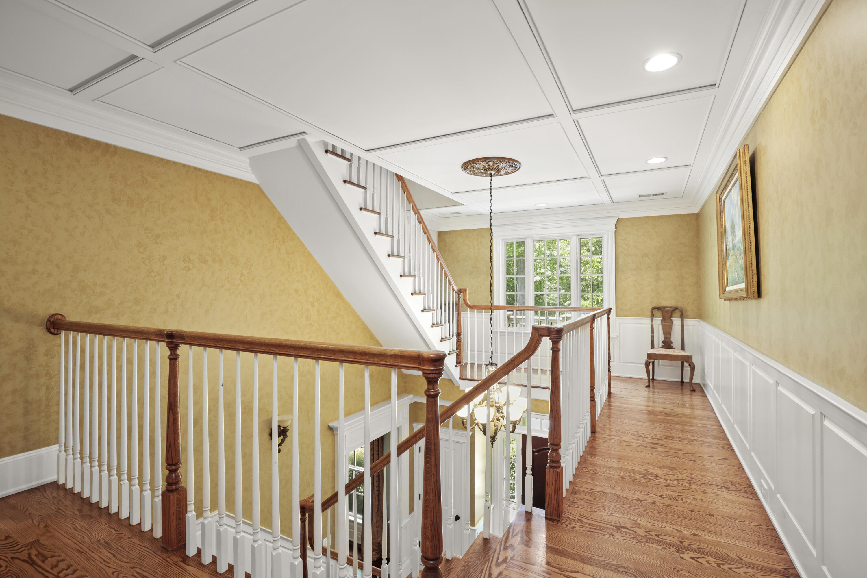 218 Limestone Road Ridgefield, CT 06877 - Photo 31 of 41 a view of a hallway with wooden floor and staircase