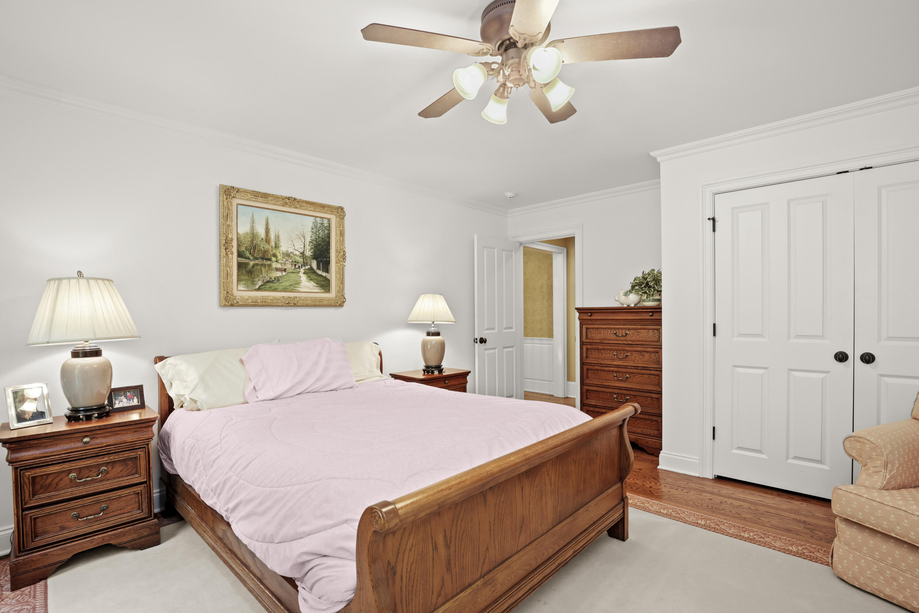 218 Limestone Road Ridgefield, CT 06877 - Photo 34 of 41 a spacious bedroom with a bed and a chandelier