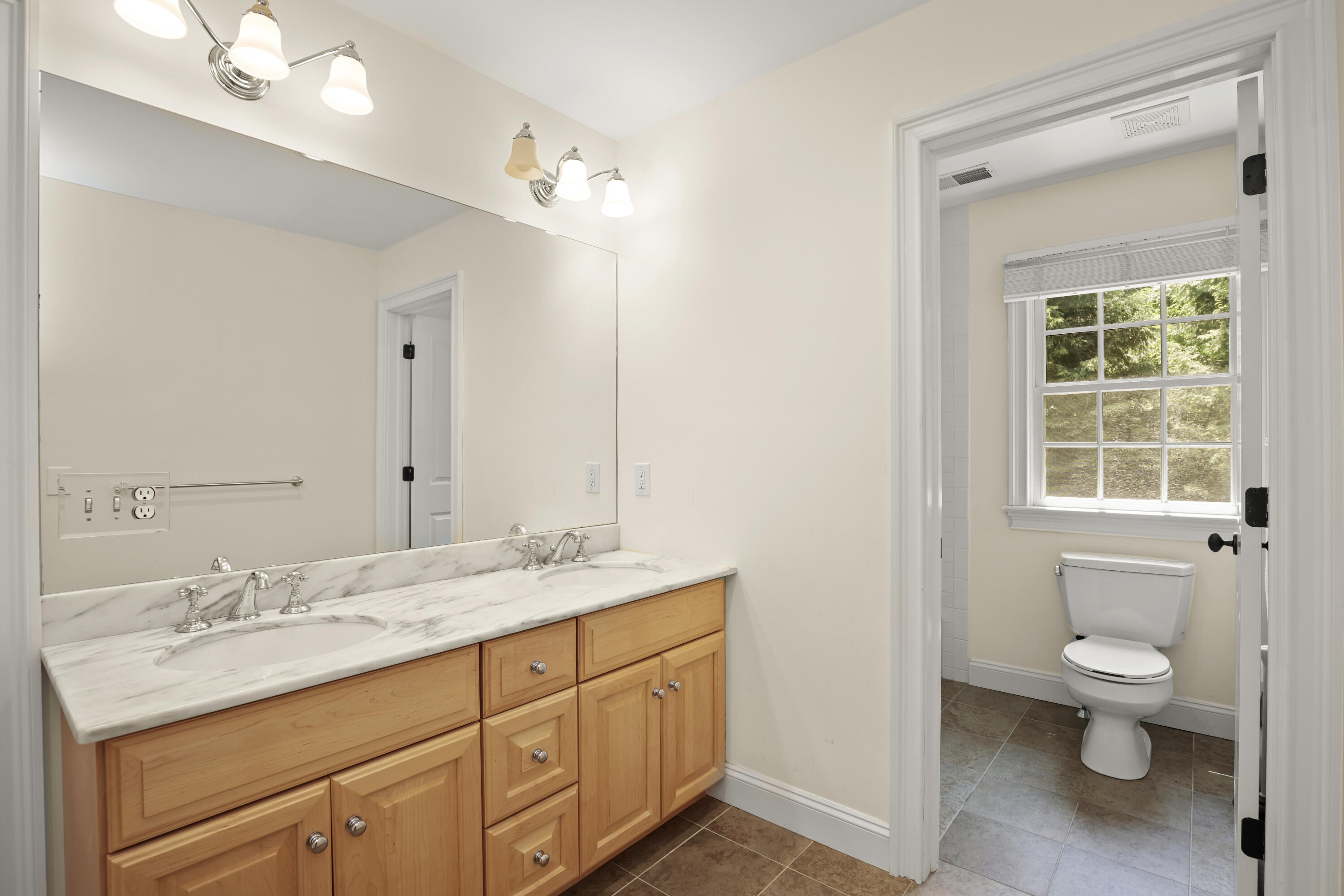 218 Limestone Road Ridgefield, CT 06877 - Photo 37 of 41 a spacious bathroom with a granite countertop sink a toilet and a mirror