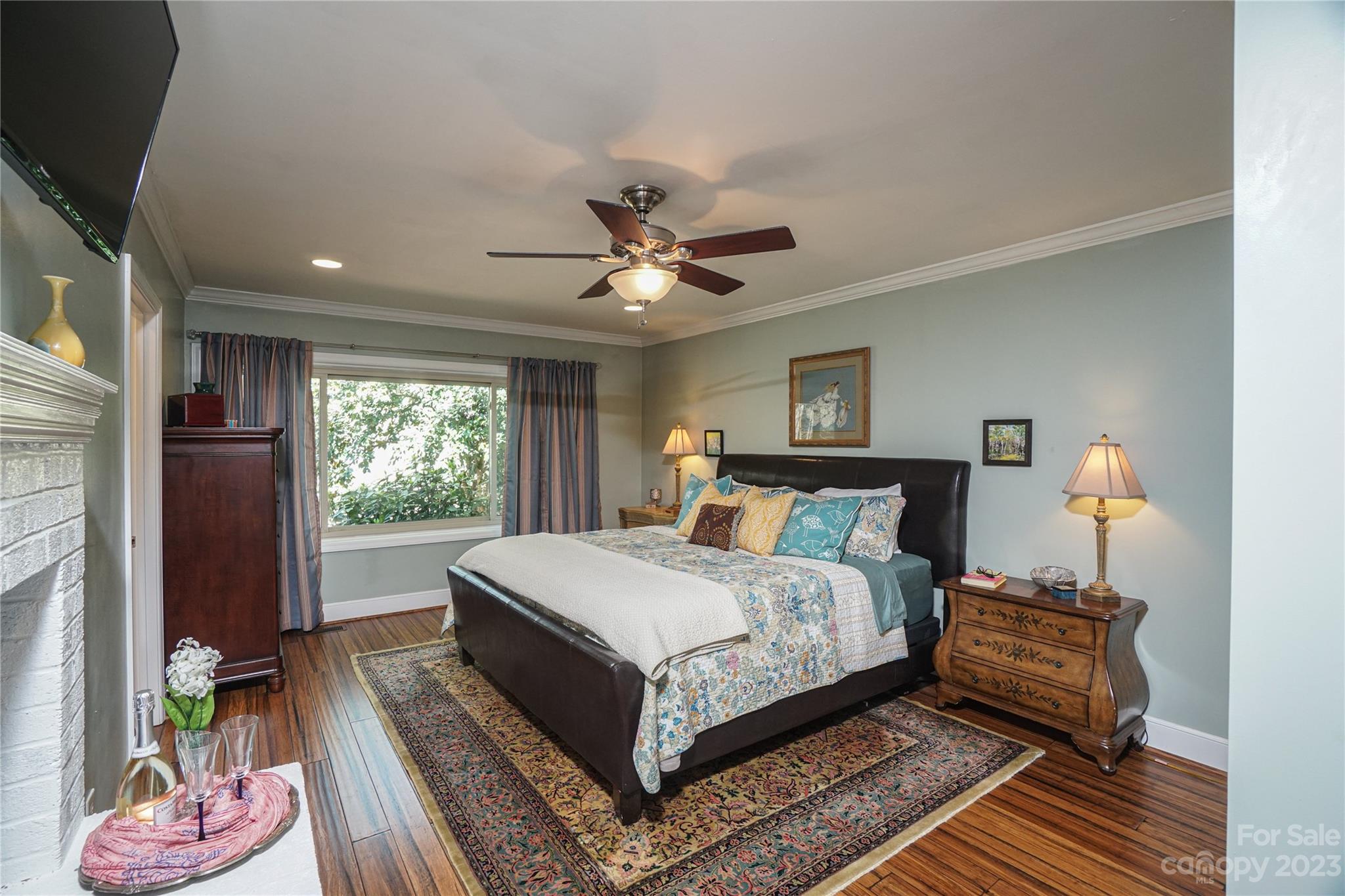 5319 Robinhood Road Charlotte, NC 28211 - Photo 20 of 26 a bedroom with a bed and a chandelier