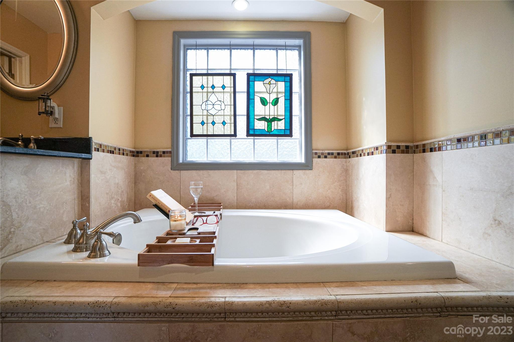 5319 Robinhood Road Charlotte, NC 28211 - Photo 23 of 26 a bathroom with a bathtub and a window