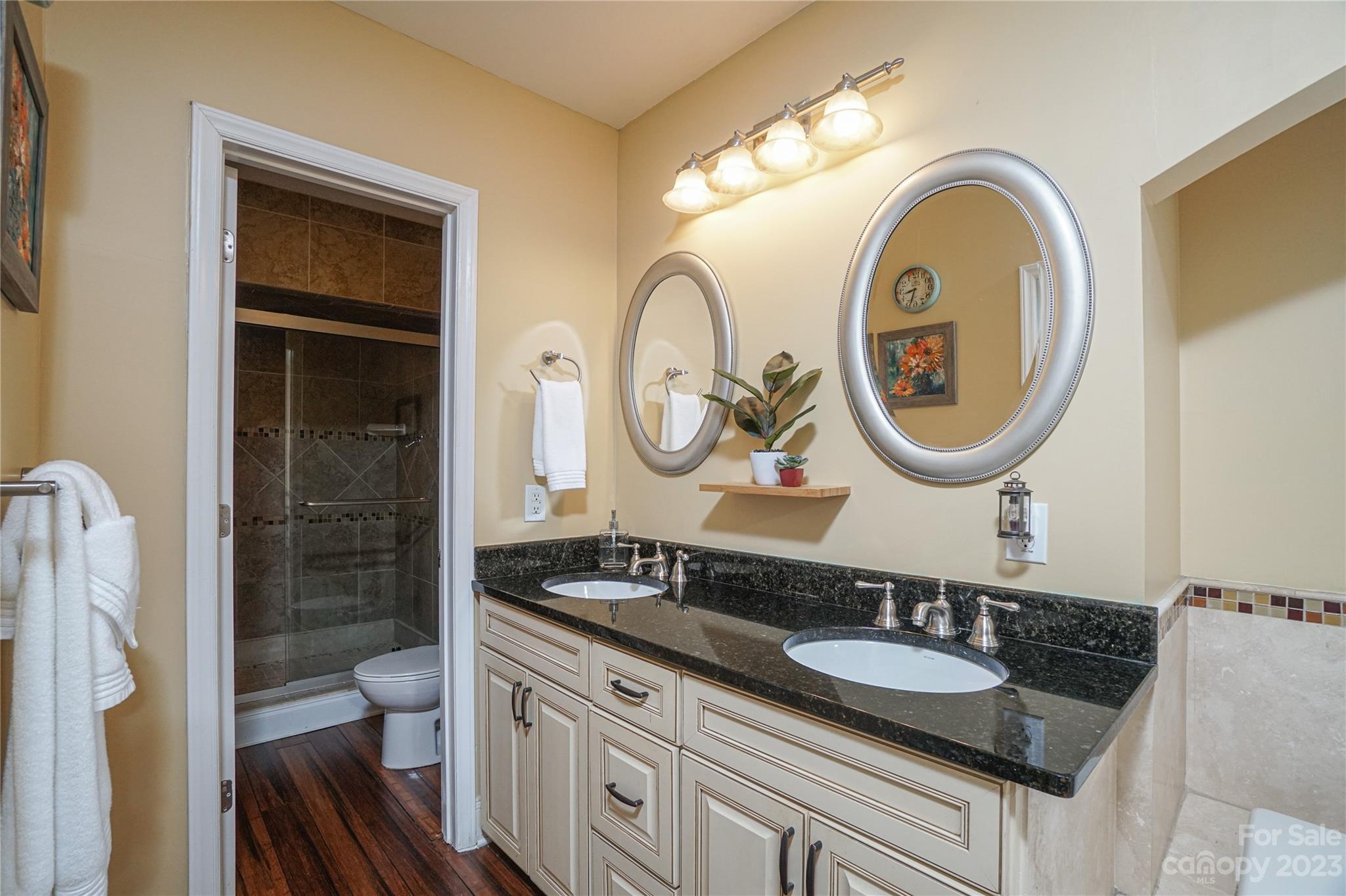 5319 Robinhood Road Charlotte, NC 28211 - Photo 24 of 26 a bathroom with a granite countertop double vanity sink and a mirror