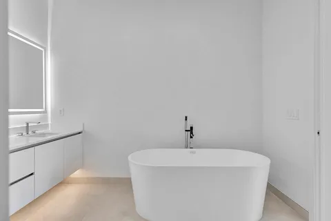 a bathroom with a bathtub and a sink